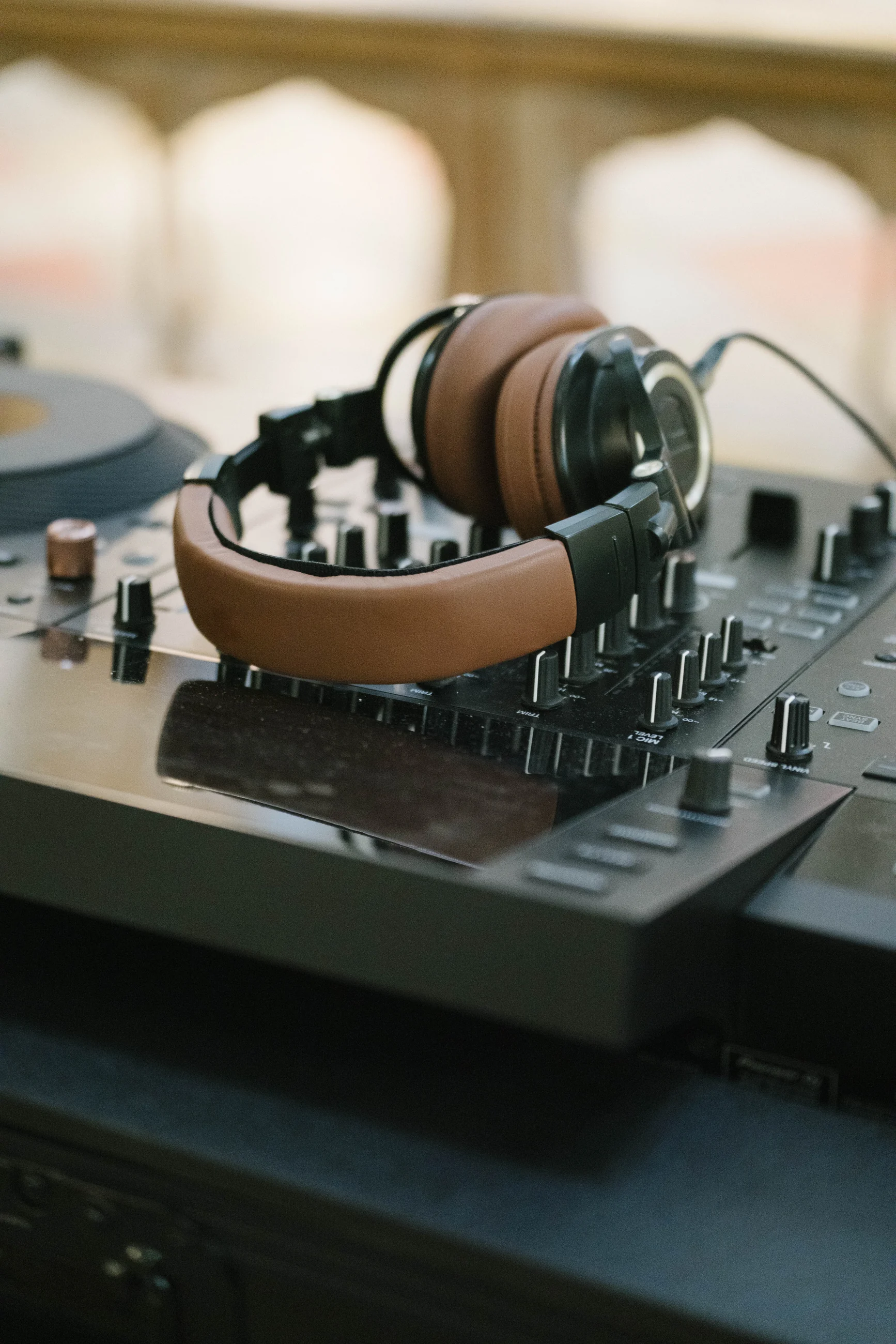 Close detail of headphones resting on DJ equipment