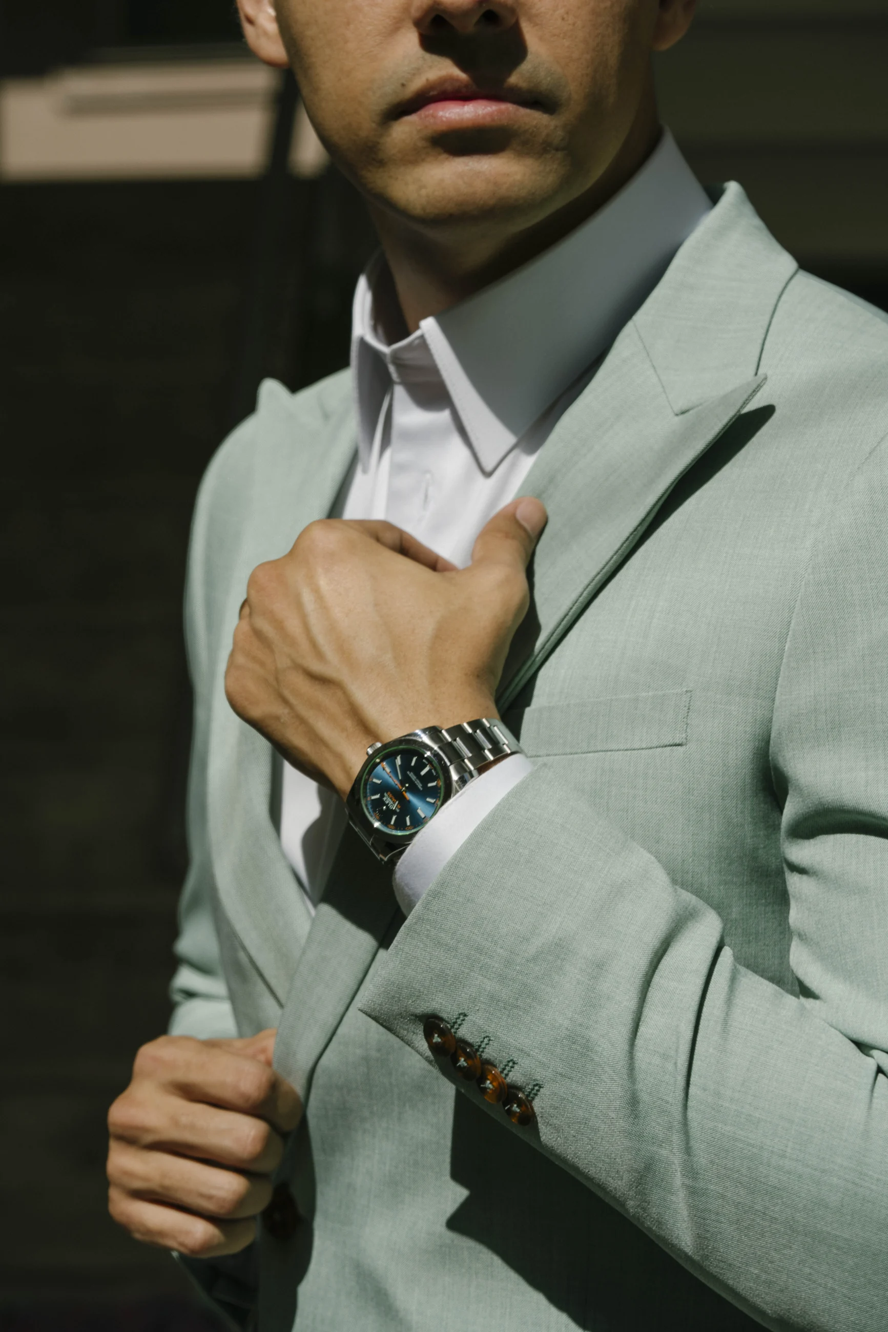 Close portrait showing the lapel and construction of a pale green suit